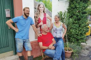 Pfalz producer Frank John (seated) with wife Gerlinde, son Sebastian and daughter Dorothea ( on a poster)