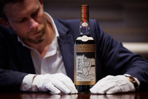 Sotheby's Global Head of Spirits with the bottle of the Macallan 1926