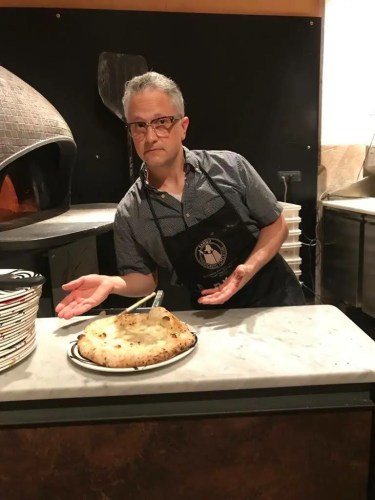 The author trying his hand at Campania's culinary signature dish: pizza