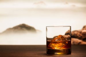 glass of whisky on mountain backdrop