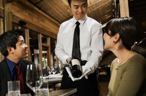 Sommelier presenting a bottle to restaurant guests