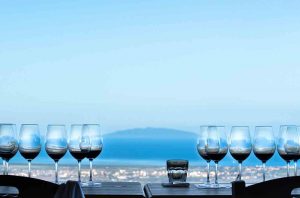 Wine tasting on sea facing terrace at Tenuta Prima Pietra winery in Riparbella, Tuscany, Italy