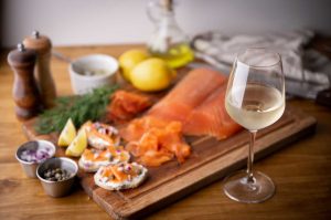 Smoked salmon on a board with white wine pairing