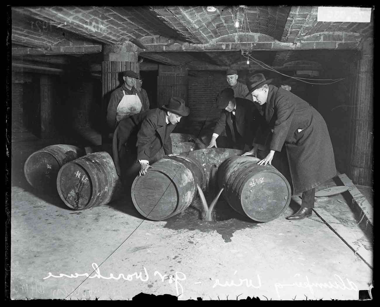 A group of men dump wine from barrels into a drain in Chicago in 1921 during Prohibition.