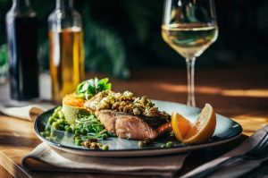 Salmon on a plate with wine pairing glass of wine