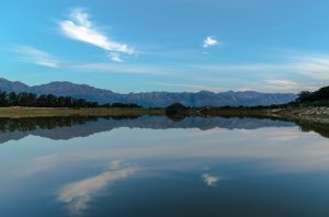 A lake with mountains in the distance