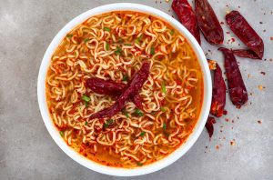 A bowk of spicy noodles with chilli