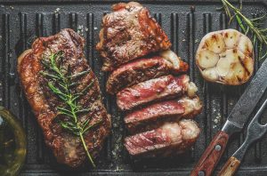 Steak and garlic on a grill