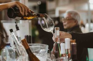 Pouring white wine at Open Balkan wine event