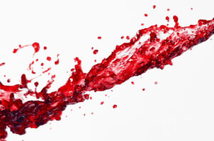 Red wine spill on white background