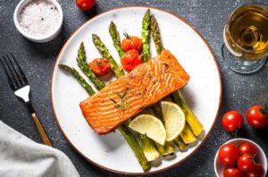 Baked salmon fish fillet with asparagus and tomato