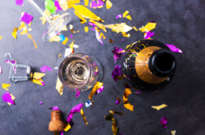 Champagne and glass with party decorations overhead shot