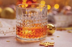 Glass of whisky with festive lights