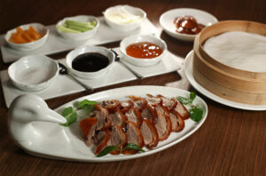 Peking duck served with pancakes, vegetables and condiment at Zither Garden, Hong Kong. Credit: South China Morning Post via Getty Images