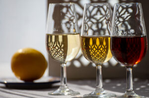 three glasses of fortified wine with lemon