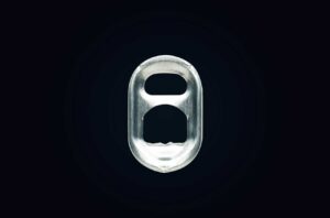 Image of auminium can tab on black background.